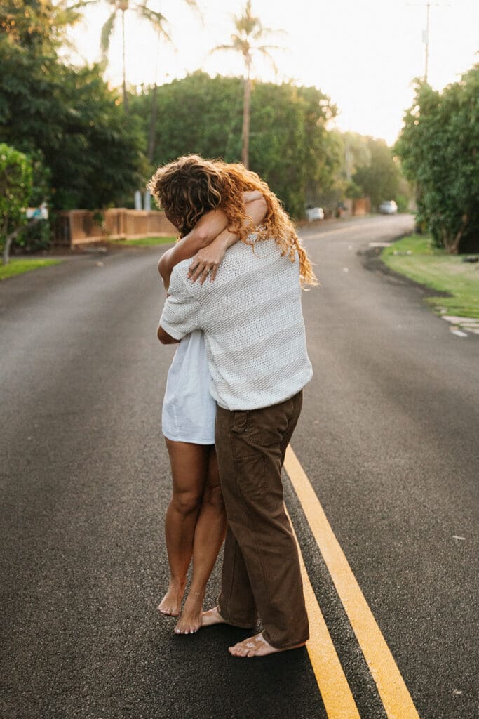 Couple Hugging On A Road On The Big Island At Sunset