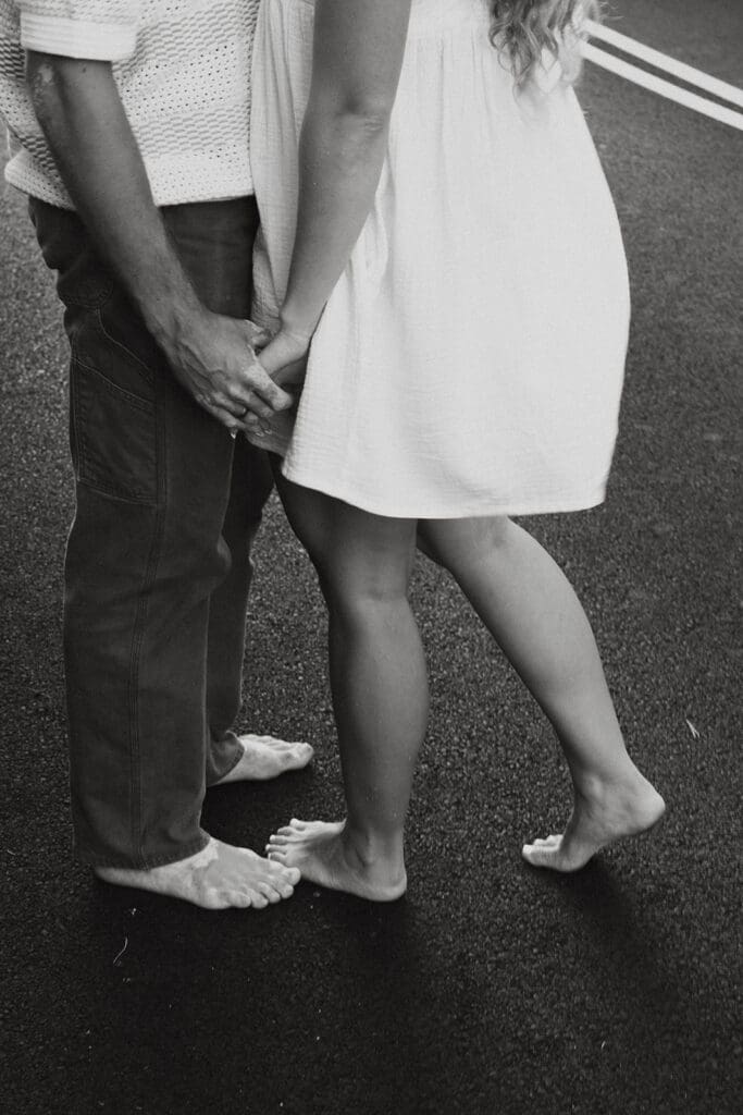 Couple Holding Hands On A Road On The Big Island At Sunset