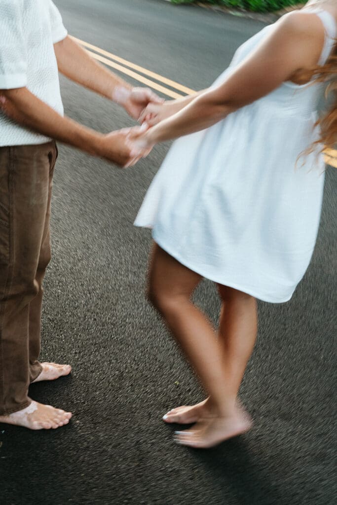 Couple Holding Hands On A Road On The Big Island At Sunset