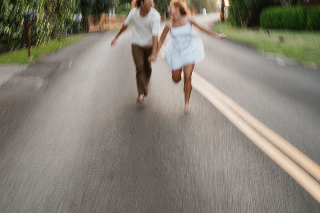 Couple Running Down a Road On The Big Island At Sunset