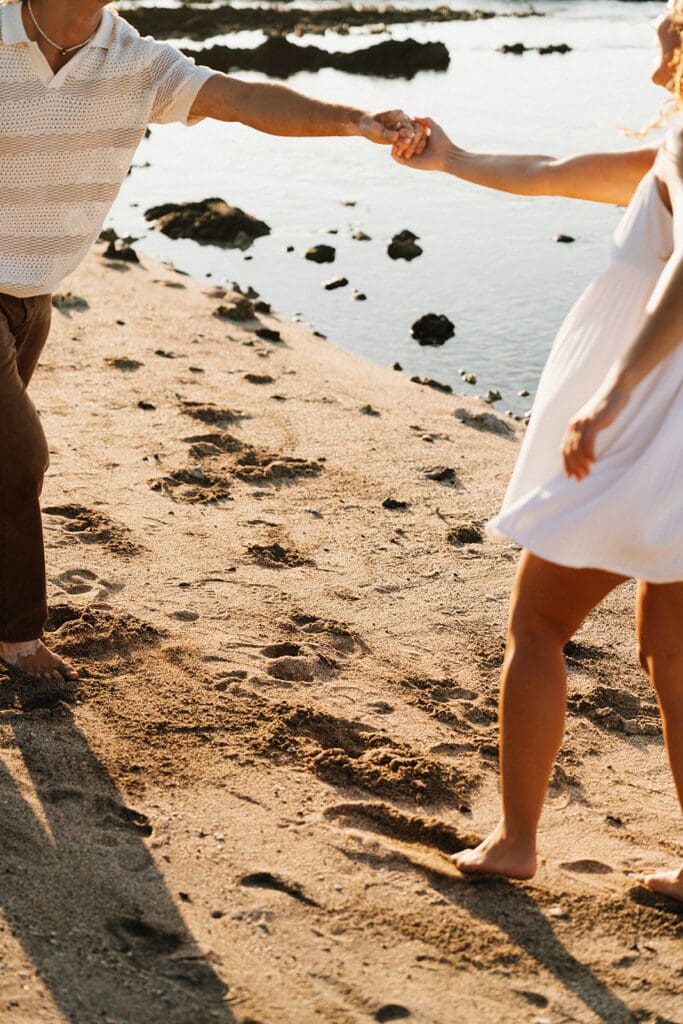 Couple Running On The Beach On The Big Island At Sunset