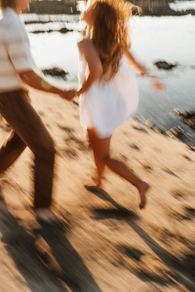 Couple Running On The Beach On The Big Island At Sunset