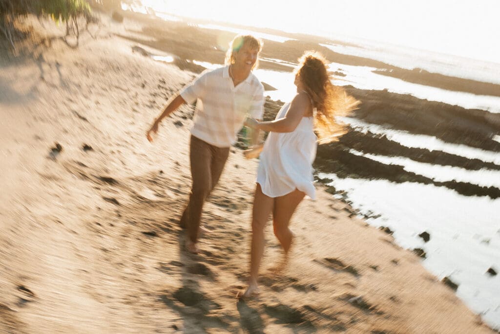Couple Running On The Beach On The Big Island At Sunset