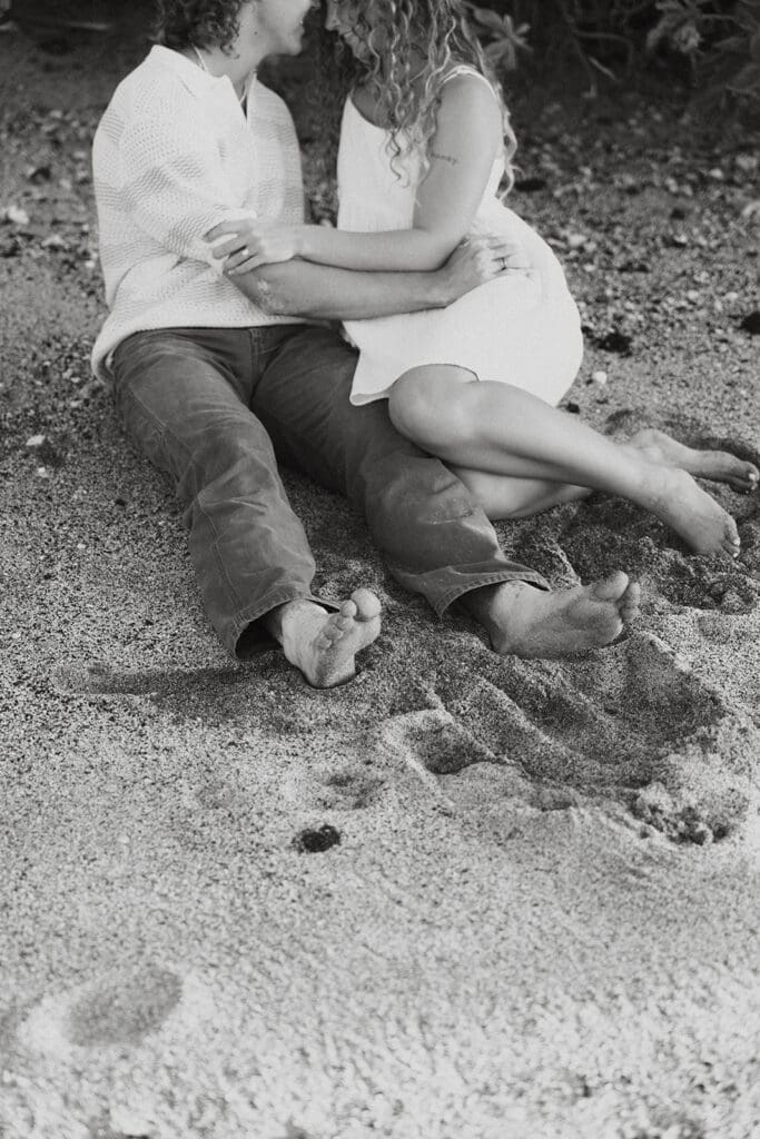 Couple Cuddling On The Beach On The Big Island At Sunset