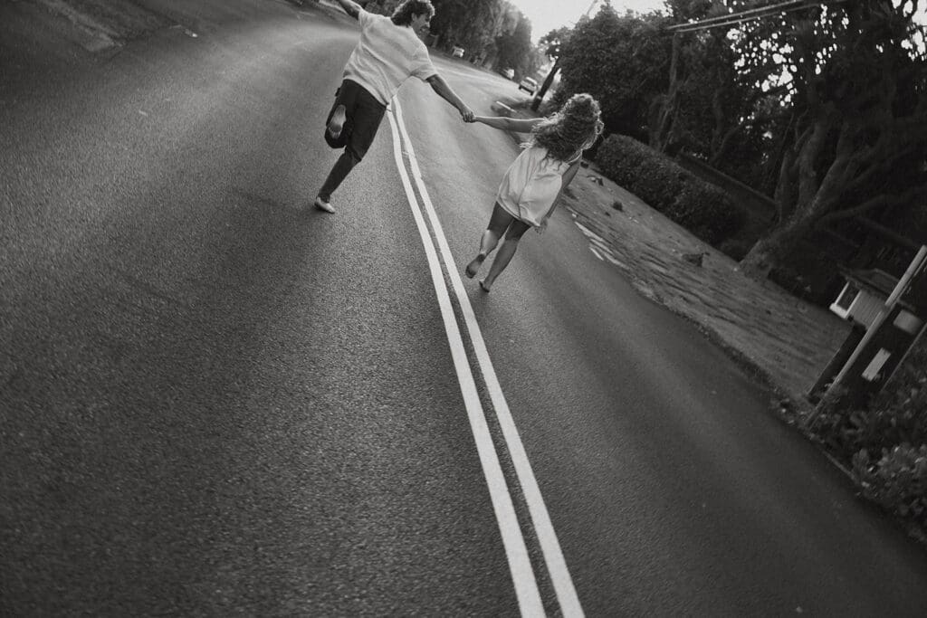 Couple Running On A Road On The Big Island At Sunset