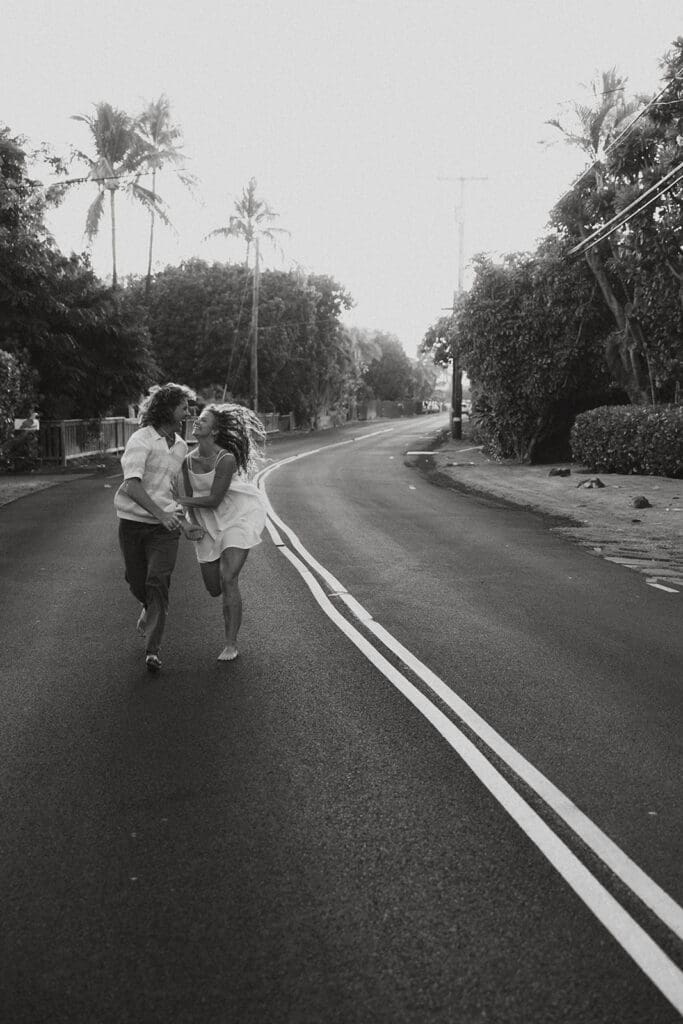 Couple Running On A Road On The Big Island At Sunset